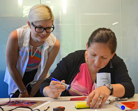 Aiva, graduate student, helps Claudia in a SpikerBox workshop